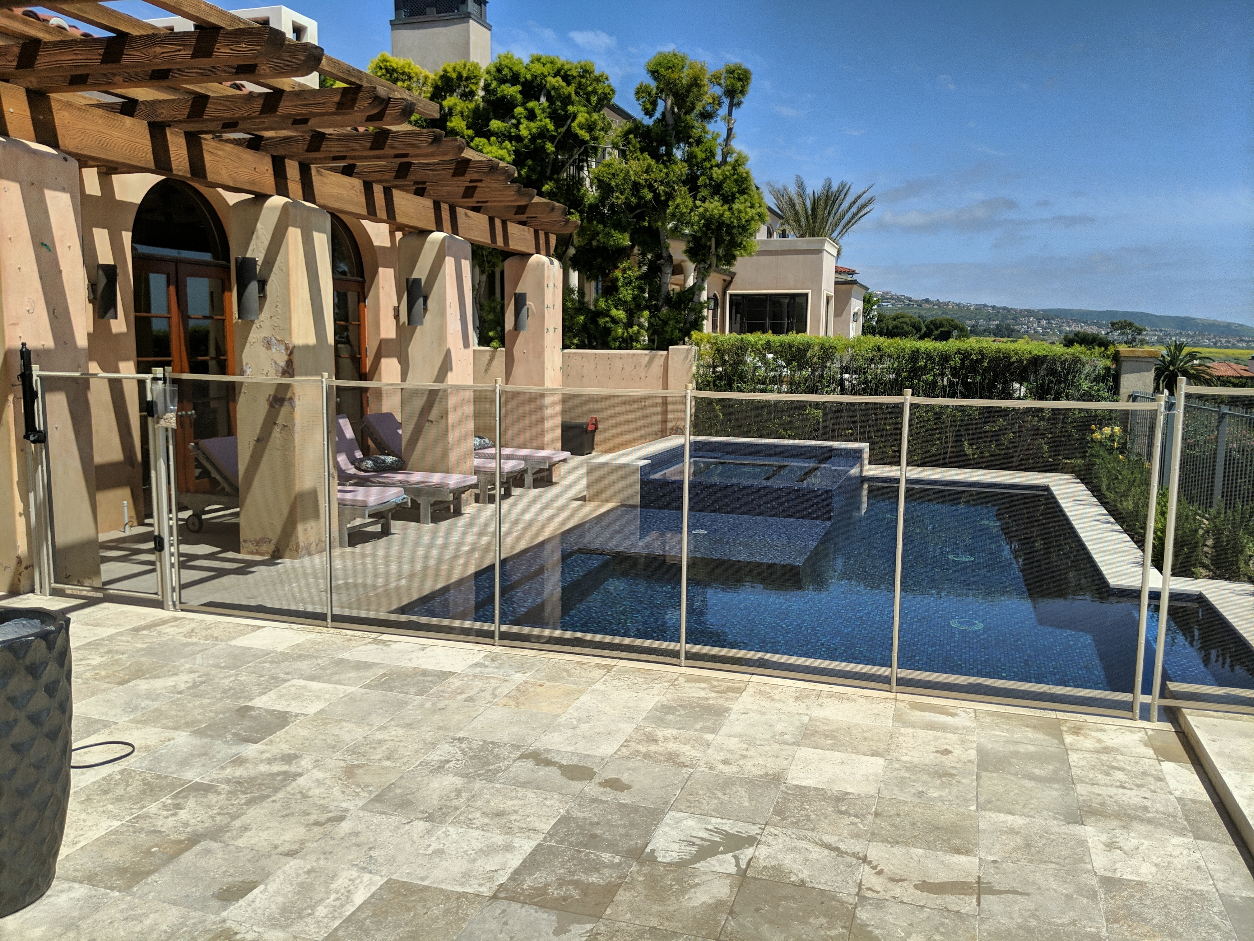 All-Safe removable mesh pool fence around a villa pool