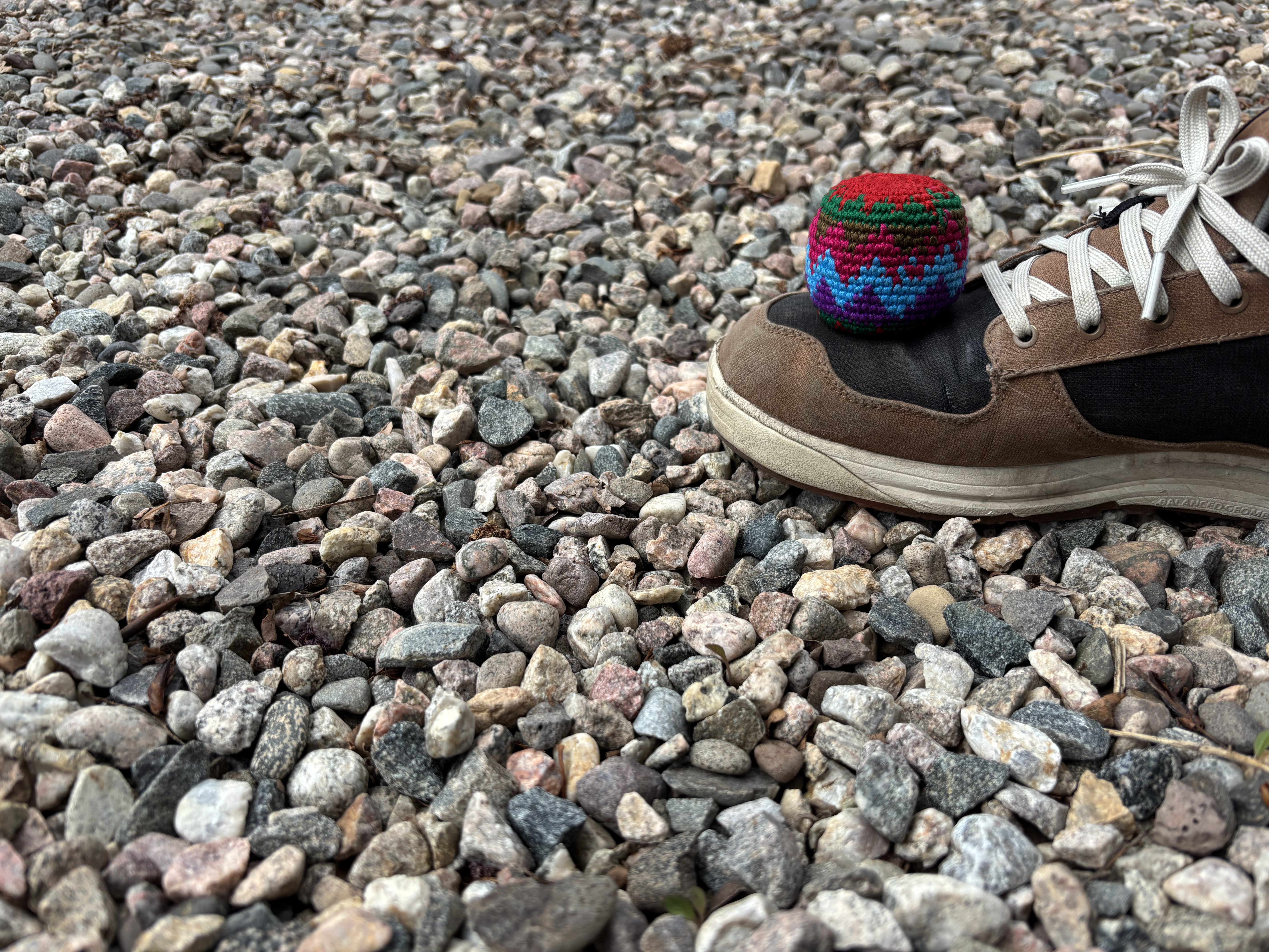 Handmade crochet footbag on shoe